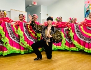 The Folkloric Dance Collective poses in traditional costumes.