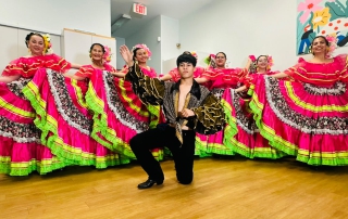 The Folkloric Dance Collective poses in traditional costumes.
