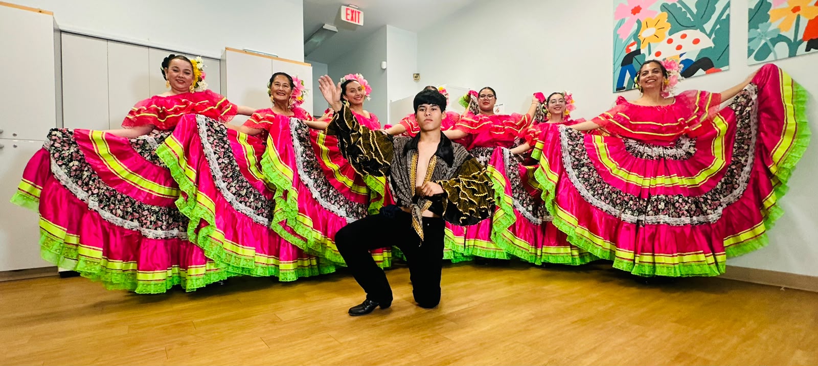 The Folkloric Dance Collective poses in traditional costumes.
